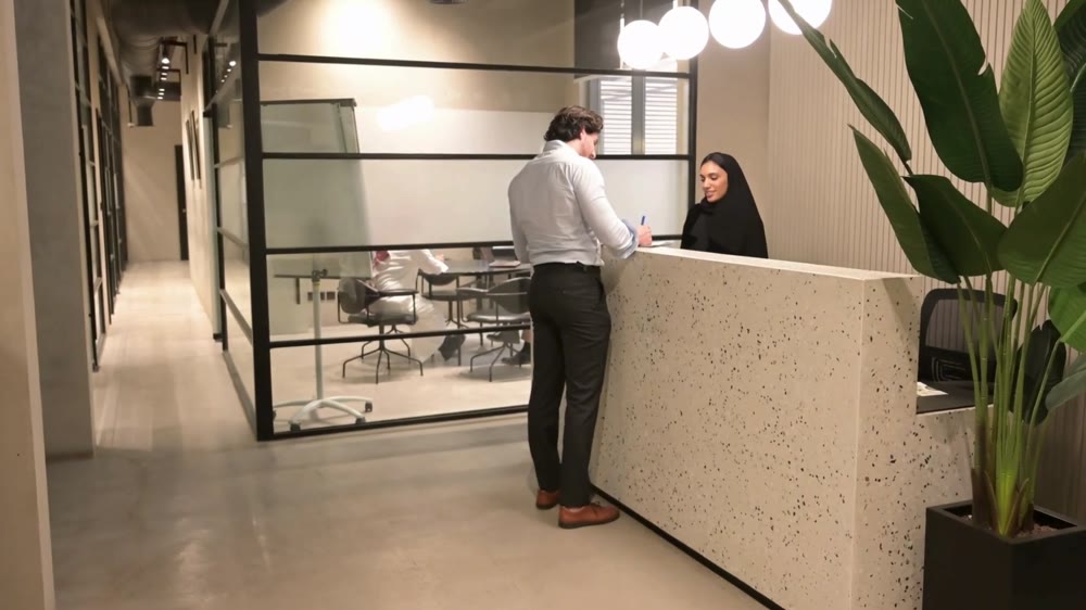 A guest speaking with a reception team member at an arrival desk
